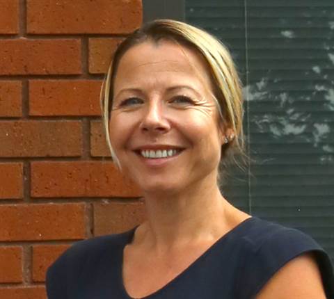 Sarah Spivey, managing director at Modulift standing in front of a brick wall
