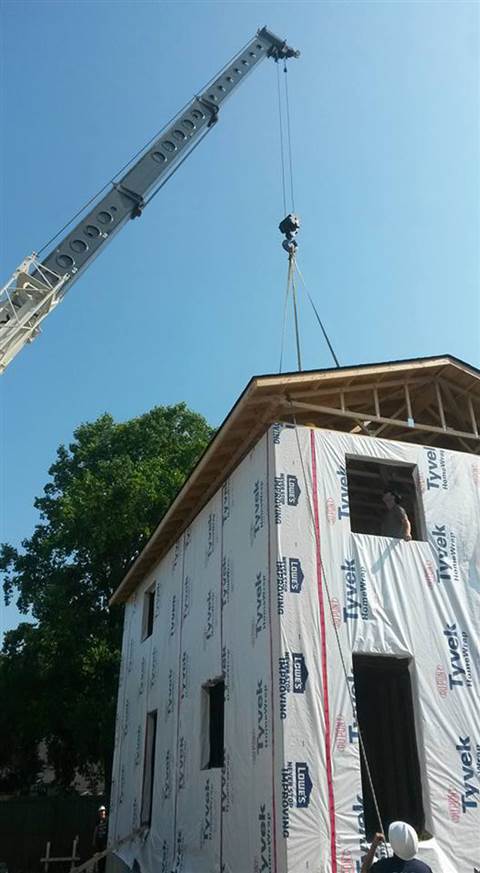 A Terex T560-1 telescopic truck crane helps out with a Habitat for Humanity project in Ontario, Cana