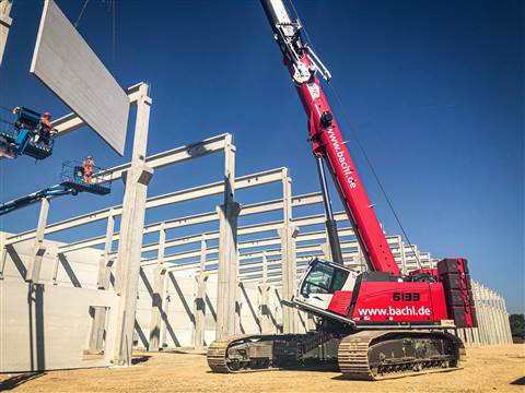 The 130 tonne capacity Sennebogen 6133 E telescopic boom crawler crane lifting and moving precast concrete parts up to 32 metres long and 35 tonnes in weight in confined spaces