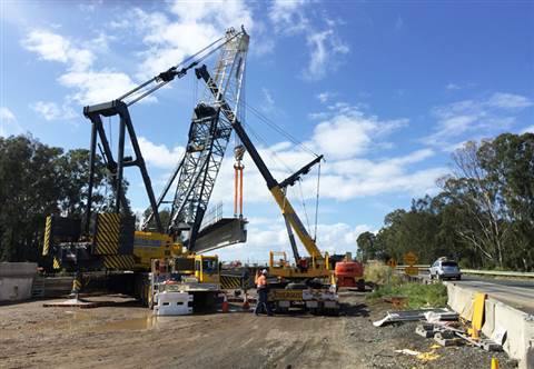 A Grove GMK7450 all terrain crane and Manitowoc M-250T lattice boom truck  crane work in tandem to i