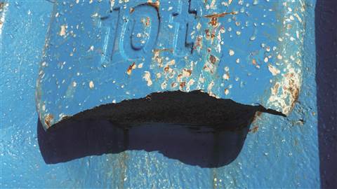 Damaged lifting point on an iron counter weight slab before Rusch repaired it